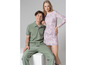 Une femme en robe rose à imprimé léopard et un homme en polo vert et pantalon.