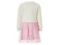 Robe enfant à manches longues avec haut crème et jupe rose à étoiles pailletées.