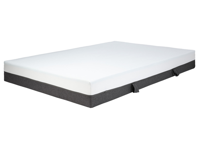 Un matelas blanc avec un dessous gris.
