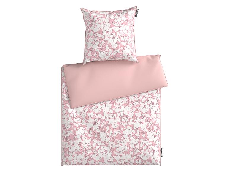 Parure de lit MICHALSKY rose avec motif floral blanc et côté rose uni.