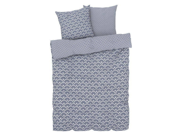 Une housse de couette avec des taies d'oreiller avec un motif géométrique en bleu et blanc.