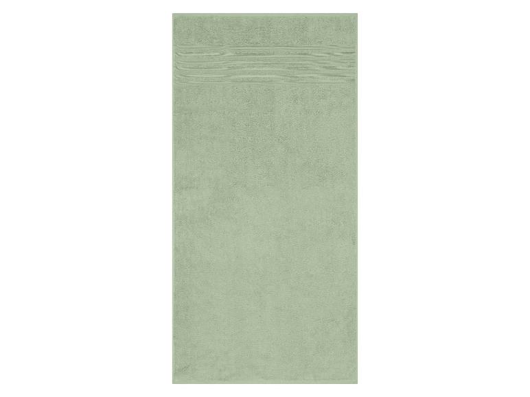 Une serviette de bain vert clair avec des rayures horizontales.