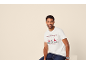 Homme en t-shirt de Noël blanc avec motif de rennes et jean