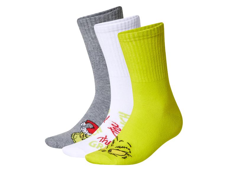 Lot de trois chaussettes sur le thème du Grinch : grises, blanches et vert fluo.