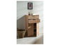 Une armoire en bois avec deux tiroirs et une porte, avec un panier à côté.