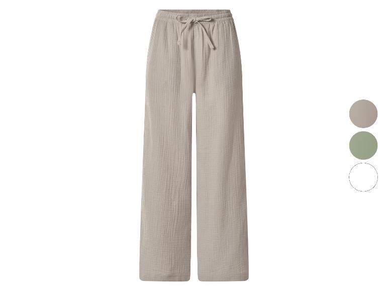 Pantalon large en mousseline beige avec taille ajustable et cordon de serrage.
