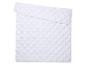 Couette blanche matelassée, pliée, avec un motif en losanges.