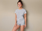 Une femme portant un t-shirt et un short gris.