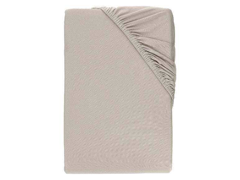 Drap-housse beige plié avec coins élastiques