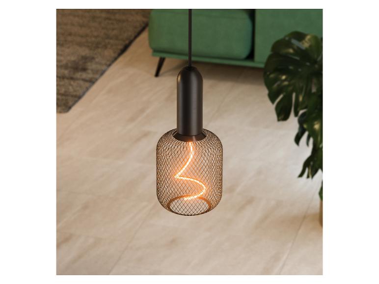 Suspension avec ampoule à filament dans un salon avec un canapé vert et une plante.