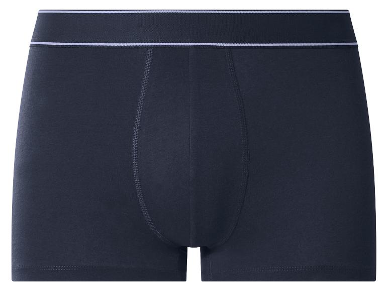 Caleçon boxer bleu foncé avec une ceinture blanche.