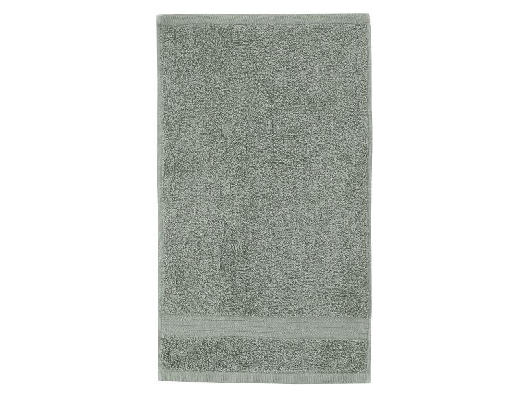 Une serviette unique, rectangulaire, vert clair avec une surface texturée.