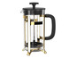 Une cafetière à piston en verre dorée avec une poignée noire.