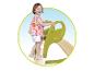 Un enfant grimpe sur un toboggan vert Smoby.