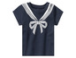 Un t-shirt bébé bleu marine avec un nœud blanc et un style marin.