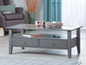 Table basse grise avec plateau en verre, deux tiroirs et une étagère ouverte.