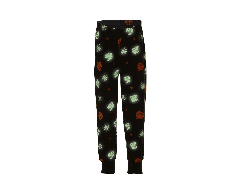 Pantalon de pyjama noir thème Halloween : citrouilles, toiles d'araignée et squelettes de dinosaures.