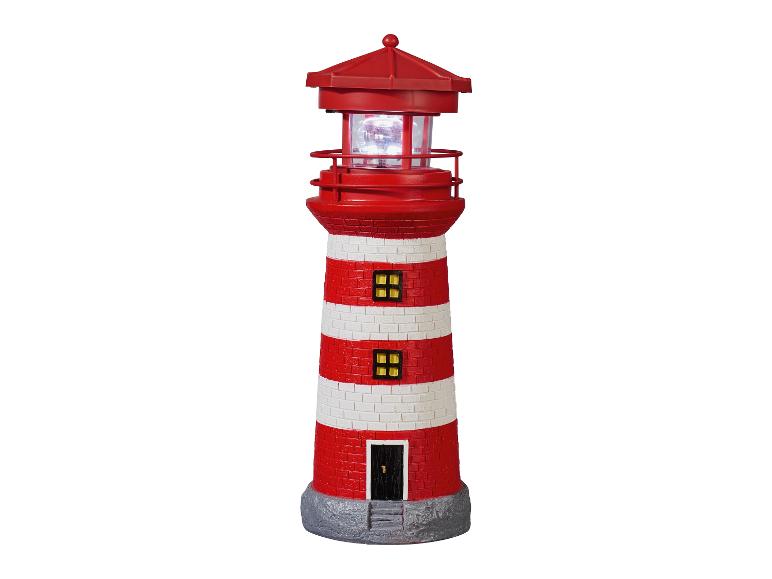 Un phare rouge et blanc avec une lumière
