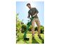 Un homme utilise une débroussailleuse Parkside pour tailler les bordures d'un jardin fleuri.
