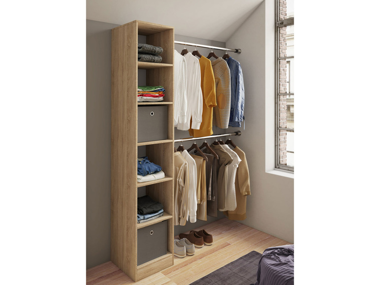Une armoire en bois avec des étagères et une barre pour suspendre des vêtements, remplie de vêtements et de chaussures