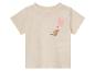 T-shirt bébé beige clair avec kangourou et ballon.