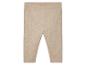 Leggings bébé beige isolés sur fond blanc.