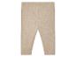 Leggings bébé beige isolés sur fond blanc.