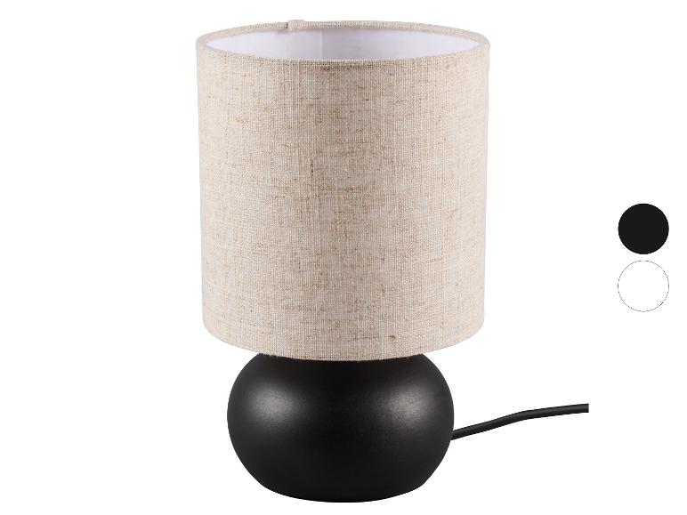 Lampe de table avec abat-jour en tissu beige et base noire, avec options de couleur.