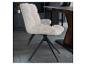 Chaise en tissu côtelé beige avec pieds en métal noir dans une salle à manger.