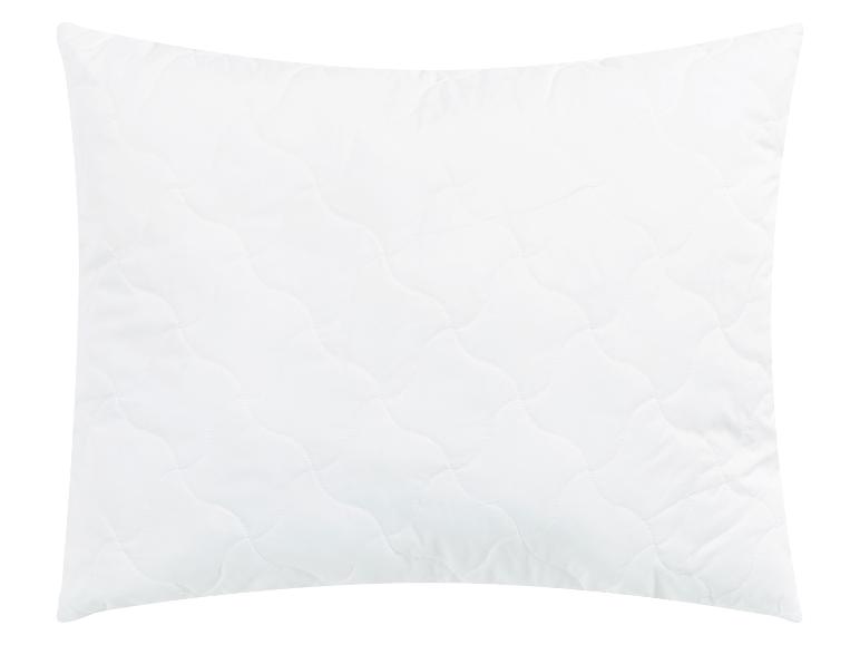 Oreiller blanc matelassé.