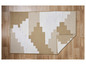 Un tapis beige et blanc avec un motif géométrique sur un sol en bois.