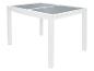 Table extensible blanche avec plateau en verre gris.