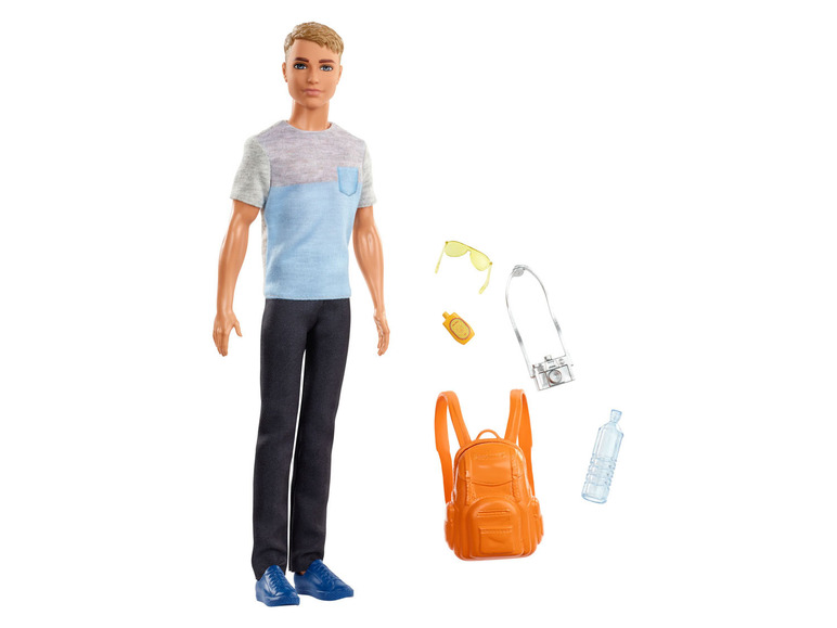 Une poupée Barbie avec des accessoires de voyage, comme un sac à dos et un appareil photo.