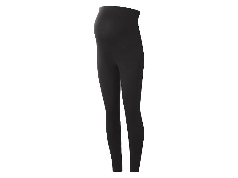 Legging de maternité noir avec un panneau sur le ventre, debout.