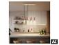 Suspension LED BRILONER avec quatre abat-jours en cuivre au-dessus d'un îlot de cuisine. [image générée par l'IA]