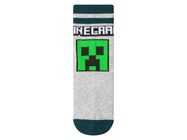 Chaussettes pour enfants avec motif de monstre vert de jeu vidéo.