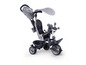 Un tricycle Smoby gris avec une capote.