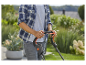 Un homme utilise une tondeuse à gazon dans un jardin.