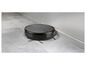 Un aspirateur robot noir Rowenta sur un sol en carrelage gris.