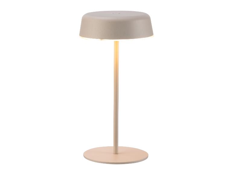 Lampe de table moderne et minimaliste beige avec base ronde et abat-jour lumineux.