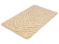Tapis de bain beige avec un motif ondulé