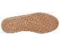 Semelle de chaussure de sport marron avec motif à pois et éléments antidérapants.