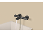 Mitigeur thermostatique de baignoire noir moderne avec de l'eau qui coule.