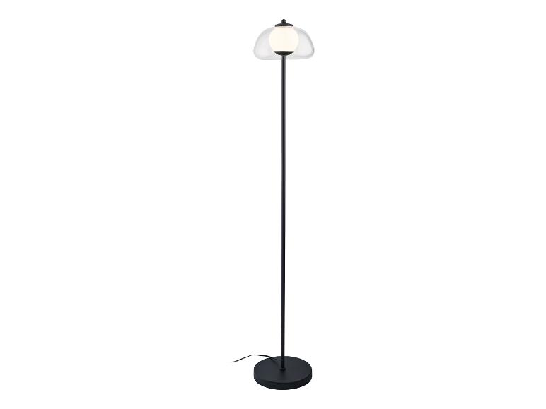 Un lampadaire noir avec un abat-jour en verre.