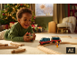 Enfant heureux jouant avec un train jouet le matin de Noël.
