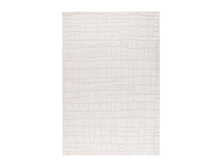 Tapis rectangulaire blanc cassé avec un motif texturé en relief.