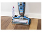 Un aspirateur Bissell Crosswave bleu avec une brosse rotative sur un sol en bois.