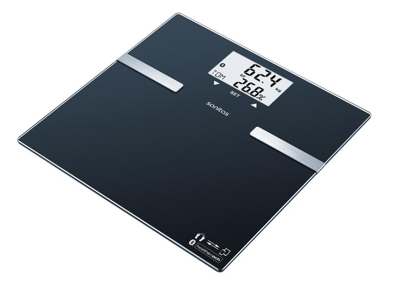 Pèse-personne numérique noir avec accents argentés, affichant 62.4 kg et 26.8% de graisse corporelle.