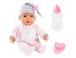 Poupée bébé en tenue rose avec bonnet, biberon et sucette.