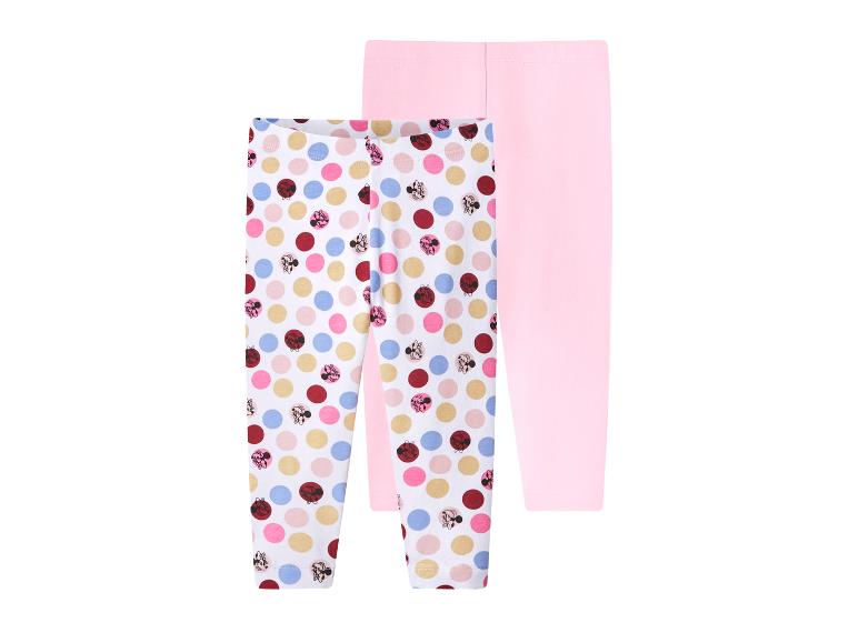 Deux leggings pour filles, un à pois colorés et l'autre rose uni.